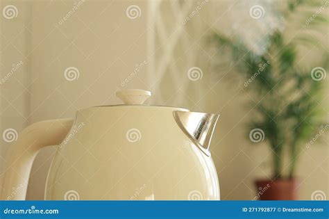 Close Up Of Boiling Water And Steam Comes Out Of White Modern Electric Kettle Teapot For Hot