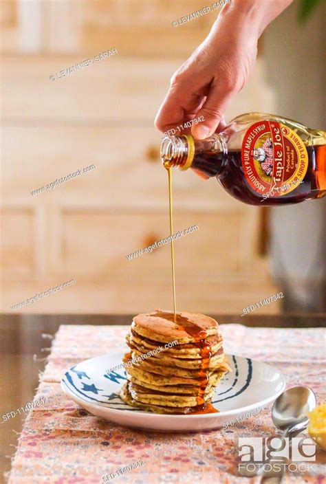 Maple Syrup Being Poured Onto A Stack Of Pancakes Stock Photo Picture