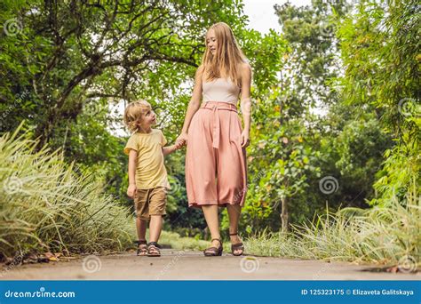 Mom And Son Are Walking In The Tropical Park Stock Image Image Of