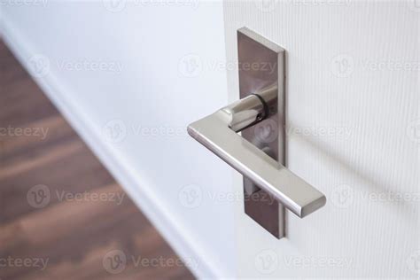 Modern door handle with on white door 12734679 Stock Photo at Vecteezy