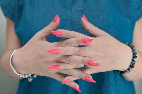 Female Hands With Long Nails And Neon Pink Nail Polish Stock Image