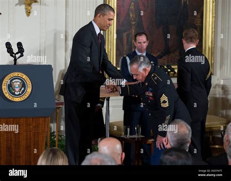 Sgt First Class Jose Rodela Is Greeted By President Barack Obama Left