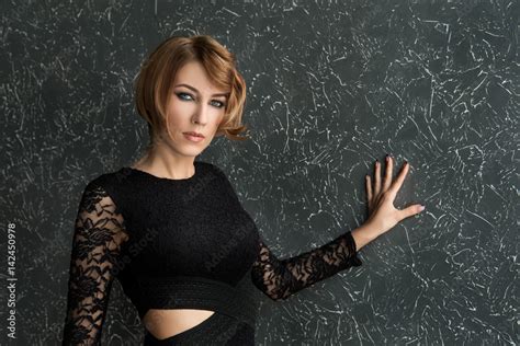 Classical Portrait Of Elegant Blonde Woman With A Wave Hairstyle And Makeup On Textural