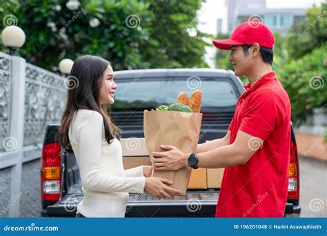 A Delivery Man Bringing Fresh Food Packages To A Customer On A Business