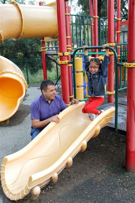 Dad With His Brunette Latina Daughter Play In The Park In The Games They Spend Quality Time In