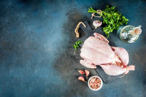 Raw Whole Chicken With Herbs And Spices On Rustic Wood Background Stock