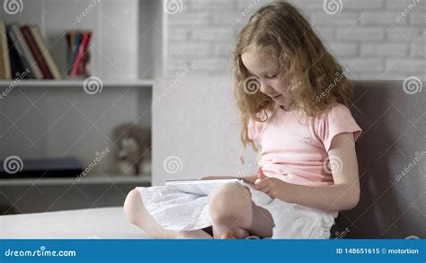 Cute Little Kid Learning Easily with Interactive Mobile App on Gadget