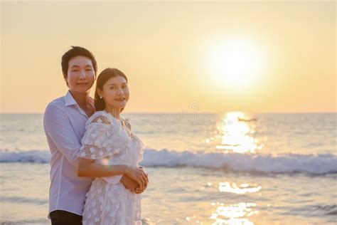 Young Happy Asian Couple Hug On The Beach Romantic Travel Honeymoon