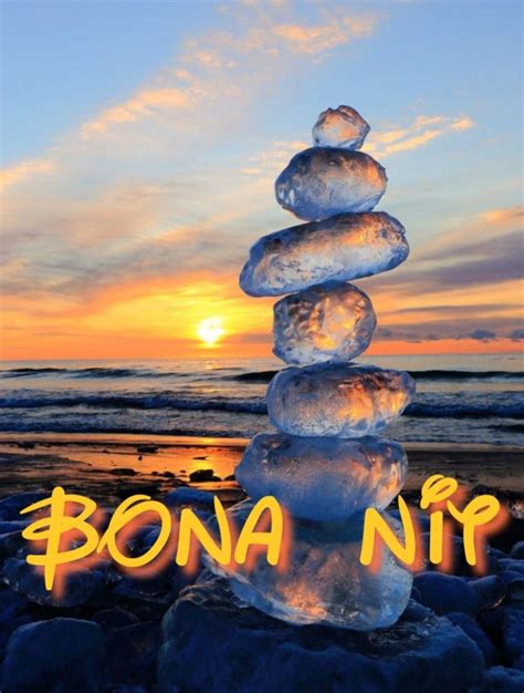 A Stack Of Ice Cubes Sitting On Top Of A Beach Next To The Ocean