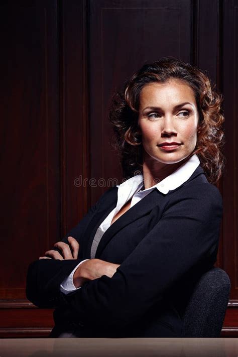 Taking My Job Seriously Attractive Mature Legal Person Sitting With Her Arms Folded And Looking