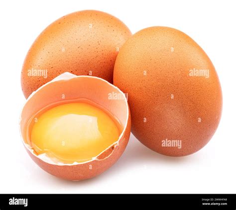 Brown Chicken Eggs And Opened Egg With Yellow Yolk Isolated On White