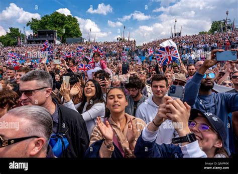 Crowds Of People Watch The Flypast Outside Buckingham Palace During The