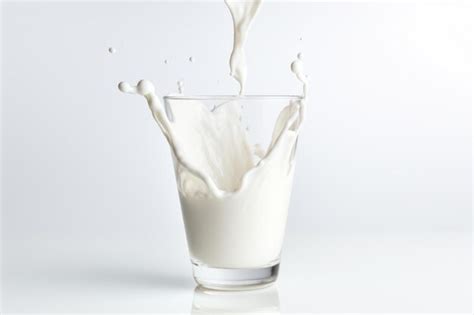 Premium Photo Milk Pouring Into Glass On White Background