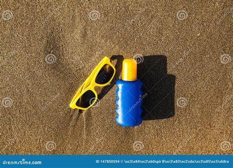 Sunscreens With Sunglasses On Clear Sea Sand On Sea Background Summer