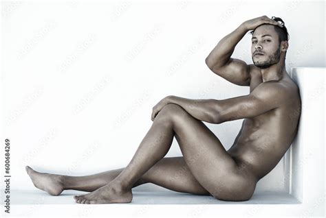 Portrait Nude And A Sexy Man Sitting On The Floor Of A Studio Against A White Background For