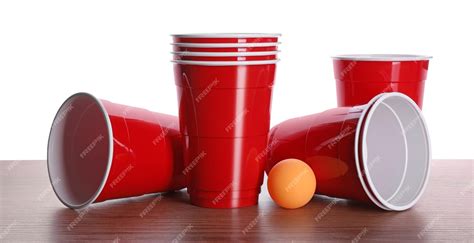 Premium Photo Plastic Cups And Ball For Beer Pong On Wooden Table