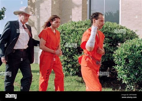 A Law Enforcement Officer Leads David Thibodeau Left And Derek Lloyd