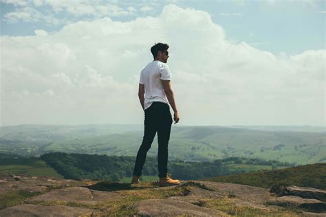 People Man Standing On Bolder Overlooking The Hills And Mountains Human