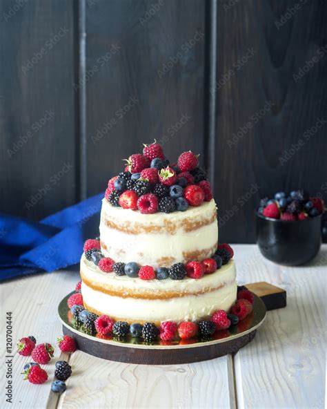 Two Tiered White Semi Naked Cake With Fresh Berries For A Wedding Or A Party Stock Photo Adobe