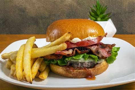 Bacon Cheese Burger On A Brioche Bun With Fries Stock Image Image Of