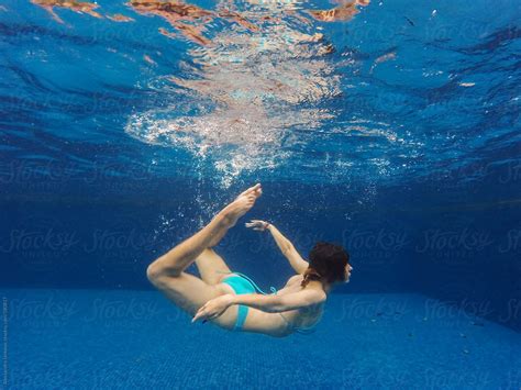 Graceful Woman Under The Water In Swimming Pool By Stocksy