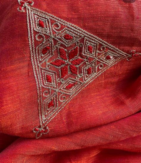 An Embroidered Red Cloth With Silver Threadwork