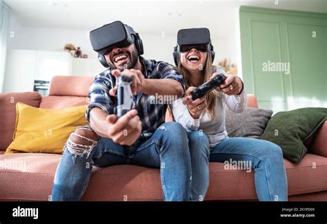 Happy Couple Playing Video Games With Virtual Reality Glasses