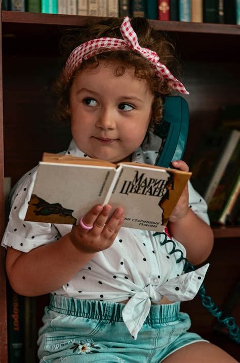 A Girl Holding a Book · Free Stock Photo