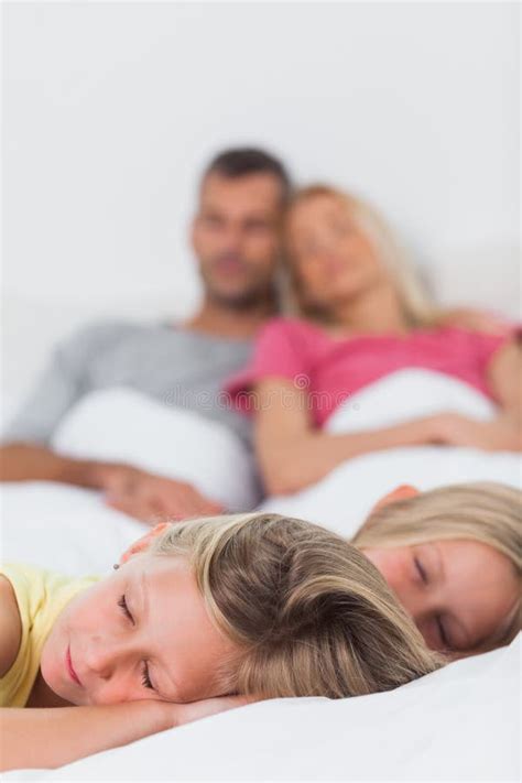 Twins Sleeping In Bed In Front Of Their Parents Stock Photo Image Of