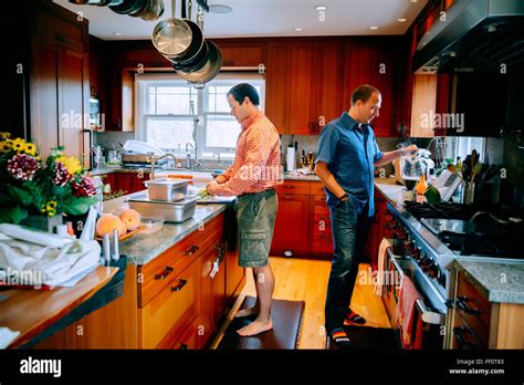 Caucasian Gay Couple Cooking In Kitchen Stock Photo Alamy
