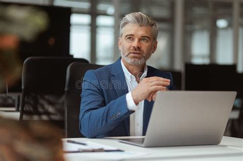 Busy Mature Businessman Workingon Laptop While Sitting In Modern Coworking Stock Image Image