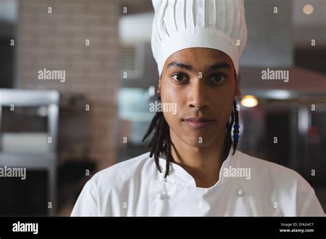 Portrait Of Mixed Race Professional Chef Wearing Chefs Hat Stock Photo