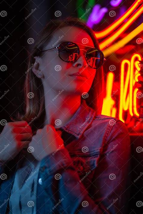 Creative Portrait Of A Girl In Neon Lighting With Glasses Stock Image