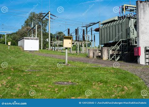 Substation In Nature With Electricity Pylons In Sunny Weather Stock