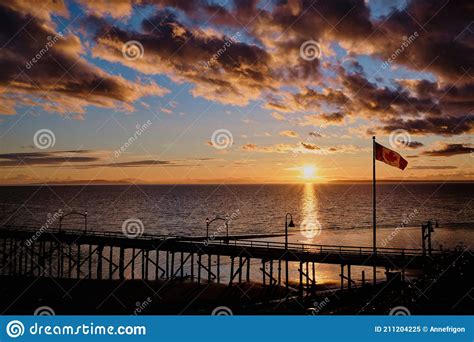 Spectacular Sunset At White Rock Pier With Canada Flag Stock Image