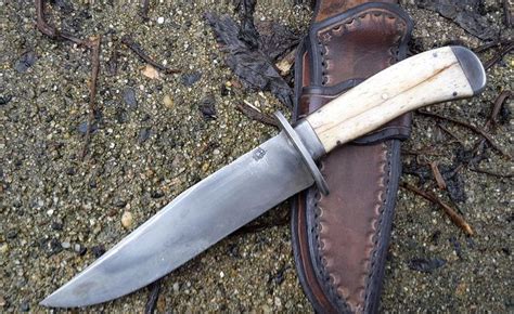 A Knife With A Wooden Handle Laying On The Ground