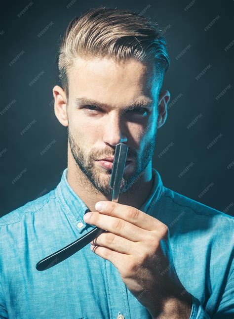 Premium Photo | Professional barber holding straight razor with sharp