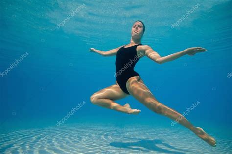 Synchronized swimmer performing underwater — Stock Photo © microgen ...