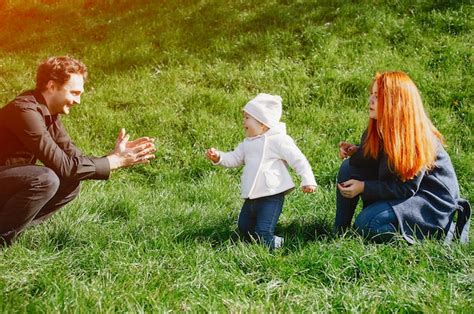 Premium Photo A Young Redheaded Mother Plays In The Park With Her