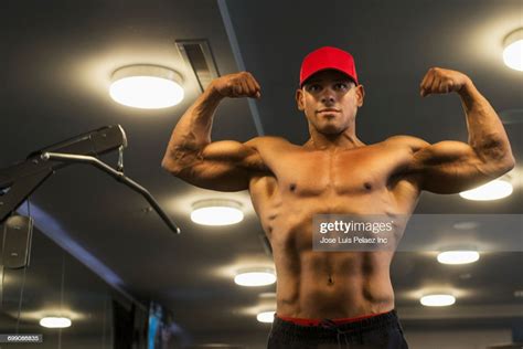 Hispanic Man Flexing Biceps In Gymnasium High Res Stock Photo Getty