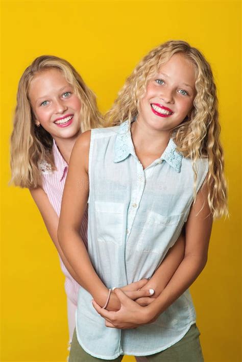 Happy Smiling Pretty Teenage Twins Girls Laughing With A Perfect Smile