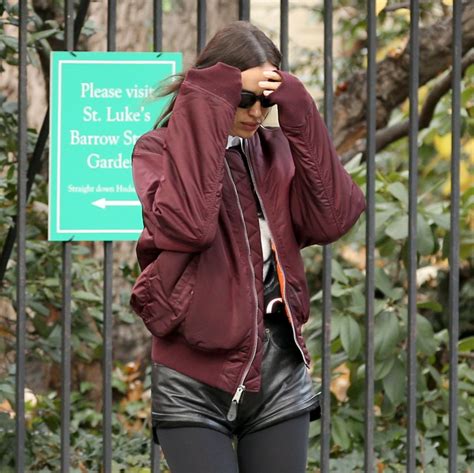 Irina Shayk Wears Black Leather Hot Pants Black Stockings Black Boots And Maroon Jacket In NYC