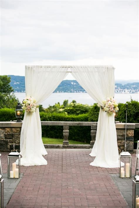 White Fabric Chuppah With Blush Arrangements