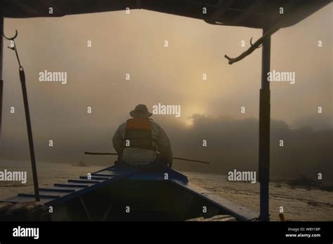 Navigating the Tambopata River at sunrise, Tambopata National Reserve, Peruvian Amazon Stock ...