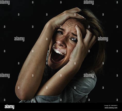 Portrait, horror and fear with woman screaming in studio on black ...