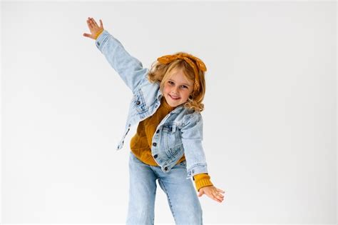 Premium Photo | Medium shot smiley girl posing in studio