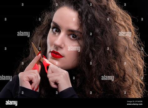 Beautiful Brunette Girl With Curly Hair Holds Scissors Stock Photo Alamy