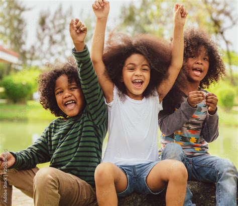 Happy Kids Group Playing In The Park In School Stock Photo Adobe Stock