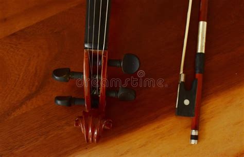 Wooden Violin With Bow On Wooden Floor Top View Classical Musical