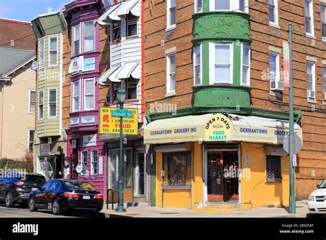 A colorful corner of Germantown with row houses and a corner store at ...